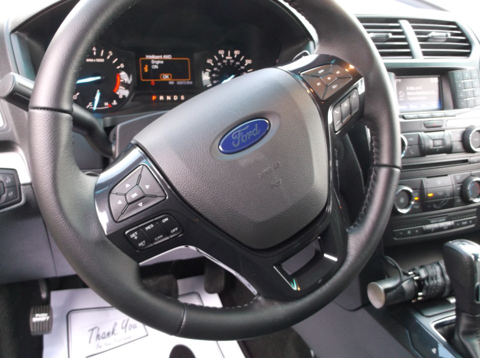 Interior view of 2016 Ford Explorer with dashboard and steering wheel