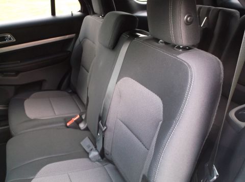 2016 Ford Explorer - The interior of a 2016 Ford Explorer shows gray fabric seats and black door panels.