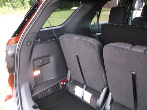 2016 Ford Explorer - The interior cargo space of an SUV, folded rear seats and a visible 'SUPERMOTORS' watermark.