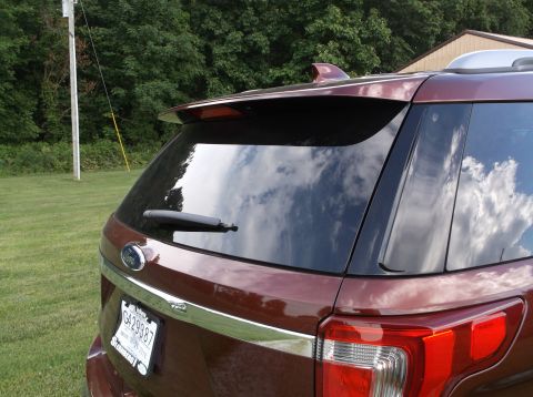 2016 Ford Explorer - The rear of a maroon SUV, identified as a 2016 model, is shown with its license plate visible.