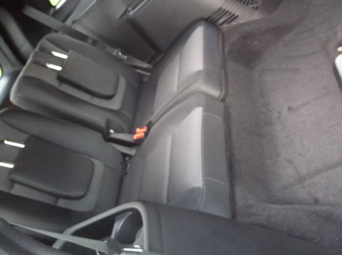 2016 Ford Explorer - The interior of a vehicle shows the rear seating area with seats folded.