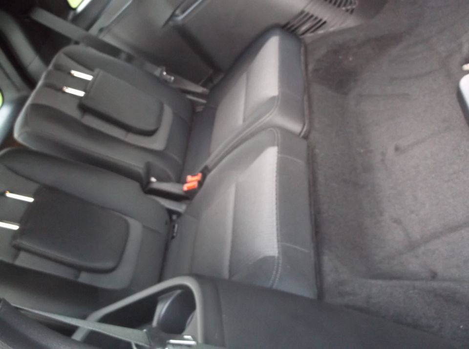 Back seats of a car, showing the second and third rows folded down