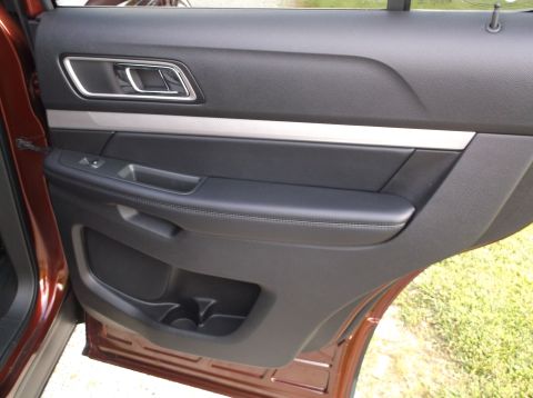 2016 Ford Explorer - Close-up of the interior door panel, showing the handle and storage compartment.