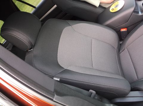 2016 Ford Explorer - The interior of the vehicle shows the front seats and center console area, with a CD resting on the armrest.