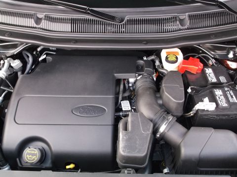 2016 Ford Explorer - Engine bay view of a Ford vehicle, showing engine components and battery.