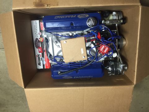 1982 Ford Bronco - Engine components, including Ford Racing valve covers and MSD ignition, are packed inside a cardboard box.