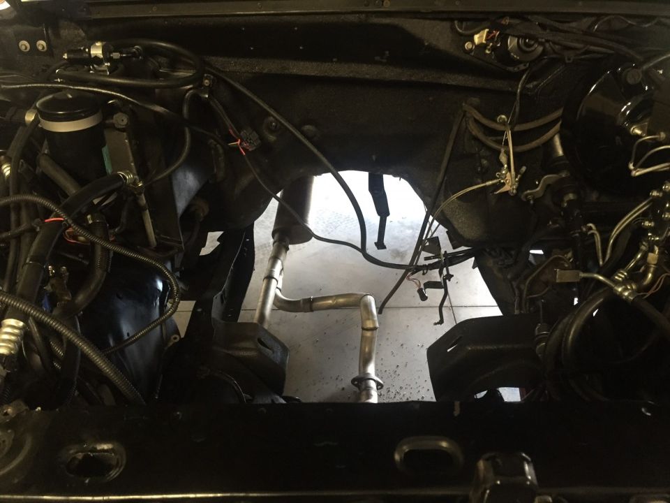 Engine bay with custom exhaust pipes and brake booster