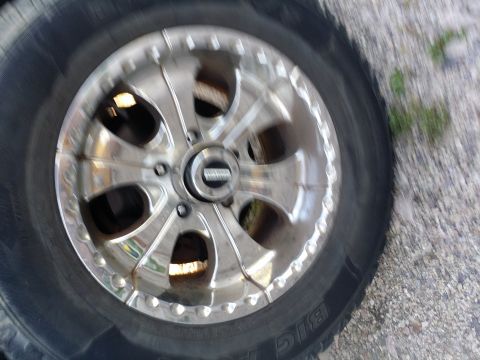 1995 Ford Bronco - Close-up of a chrome wheel and tire, likely an aftermarket part.