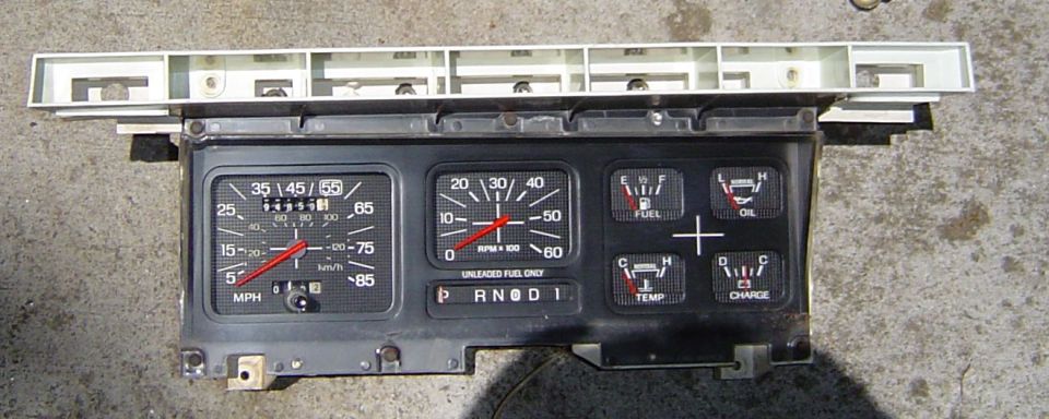 Dashboard gauges with speedometer, tachometer, fuel, oil, temp, and charge indicators