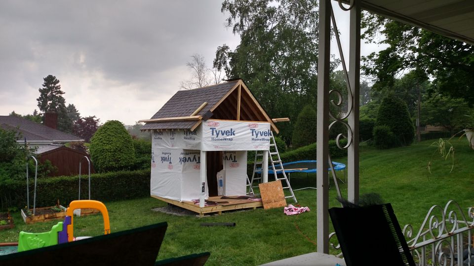Playhouse under construction with Tyvek wrap and ladder