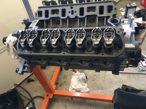 1987 Ford Bronco - Engine components are visible on an orange stand, suggesting a rebuild or repair process.
