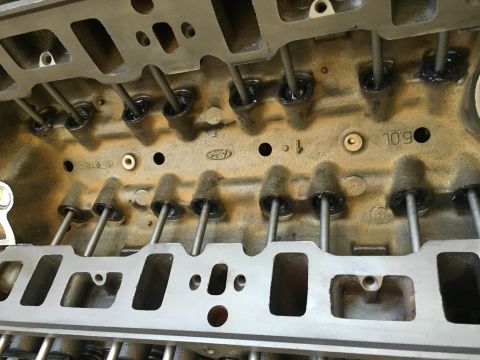 1987 Ford Bronco - Ford engine cylinder head with pushrods visible, intake ports in view. '5.0L' marking present.