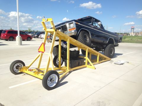 1979 Ford Bronco - Black 1979 Ford Bronco positioned on a yellow ramp, likely for display or modification.