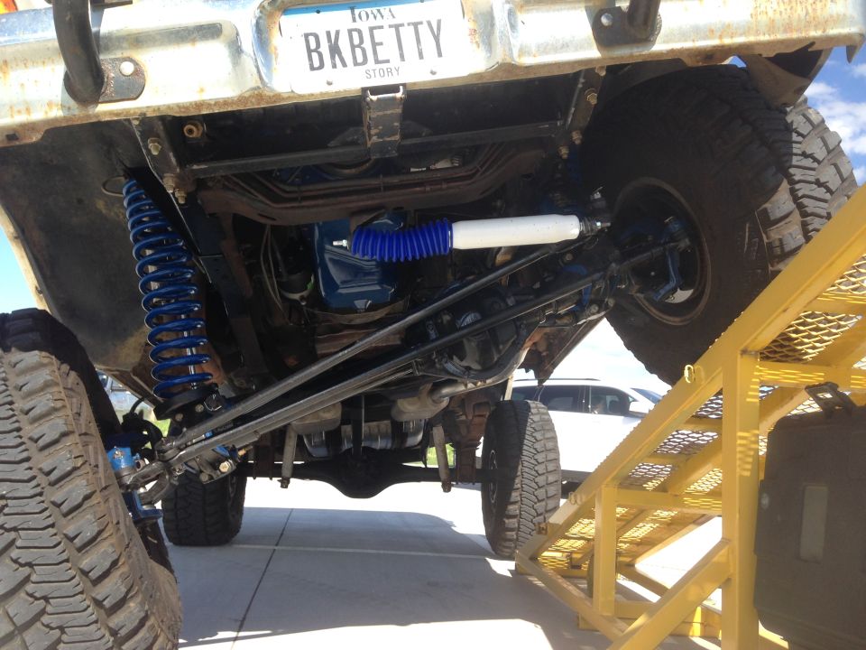 Undercarriage of 1979 Ford Bronco with blue suspension and white shock absorber