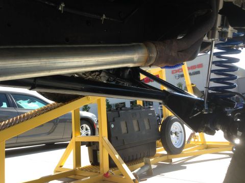 1979 Ford Bronco - Undercarriage view shows suspension and exhaust components, with other vehicles visible in the background.