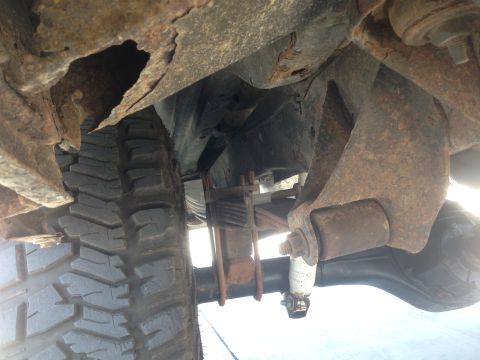 1979 Ford Bronco - Heavily rusted vehicle frame and suspension components, showing significant deterioration.