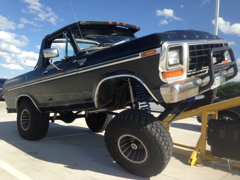 1979 Ford Bronco - This black Ford Bronco has a lifted suspension and is positioned on a yellow ramp.
