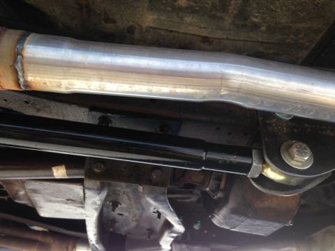 1979 Ford Bronco - Close-up of vehicle undercarriage components, including exhaust and suspension parts.