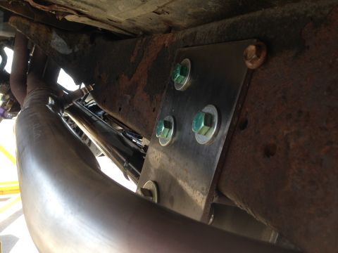 1979 Ford Bronco - Custom exhaust pipe installation on a rusty vehicle frame.