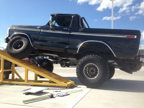 1979 Ford Bronco - 1979 Ford Bronco shown on a yellow ramp, highlighting its suspension and off-road capabilities.