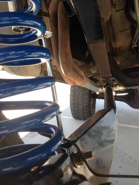 1979 Ford Bronco - Close-up of vehicle suspension components and exhaust system.