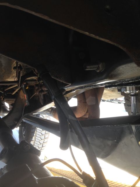 1979 Ford Bronco - This photo shows the underside of a vehicle, focusing on mechanical parts and the frame structure.