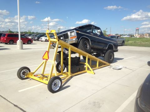 1979 Ford Bronco - Black 1978 Ford Bronco on a yellow ramp, likely for suspension work or display.