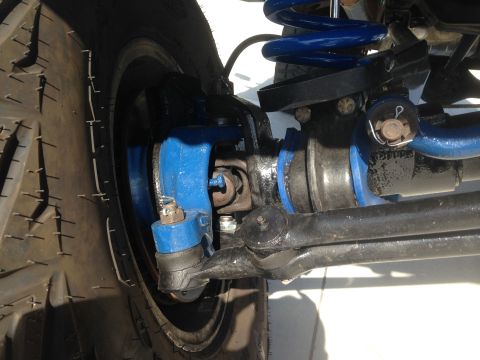 1979 Ford Bronco - Detailed view of the suspension system, showing various mechanical parts and a tire.