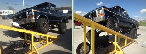 1979 Ford Bronco - This black 1979 Ford Bronco is shown on yellow ramps, demonstrating its lifted suspension and off-road capabilities.