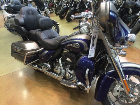 2004 Harley-Davidson Fat Boy - A blue and silver Harley-Davidson touring motorcycle is displayed indoors with other bikes.