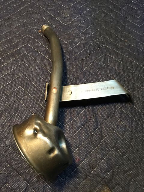 1978 Ford Bronco - Ford oil pump pickup tube, part number 077E-6622-AB, shown on a quilted surface.
