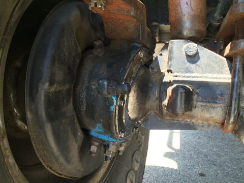 1987 Suzuki Samurai - Detail of a heavy-duty truck's axle and brake system, showing mechanical components.