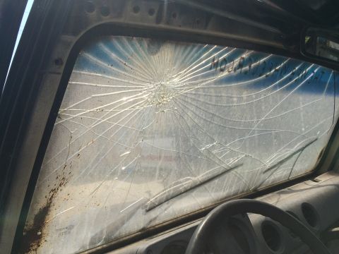 1987 Suzuki Samurai - The windshield is heavily damaged with spiderweb cracks radiating from a central impact point.