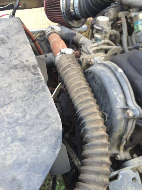 1987 Suzuki Samurai - Close-up view of a vehicle's engine bay, showing various hoses and components.