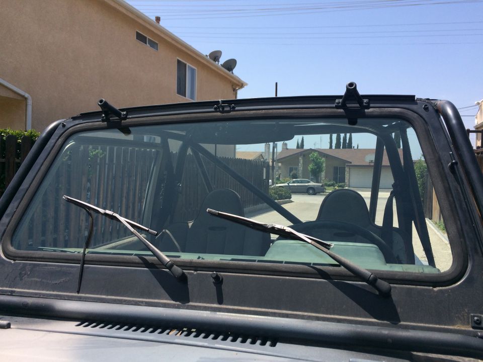 1987 Suzuki Samurai windshield wipers and interior roll cage visible