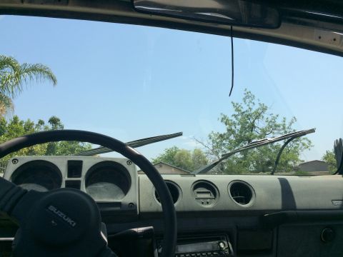 1987 Suzuki Samurai - Interior view of a Suzuki Samurai, showing the dashboard and steering wheel.