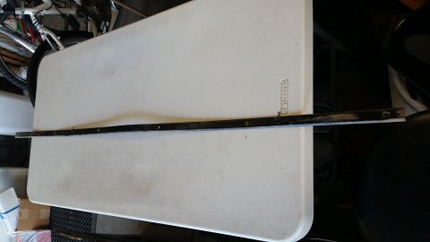 1992 Ford Bronco - This is a trim piece, likely for a vehicle's rear window, shown on a table.