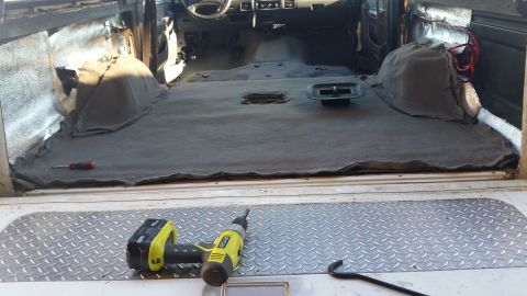 1992 Ford Bronco - Vehicle interior undergoing carpet removal and repair work.