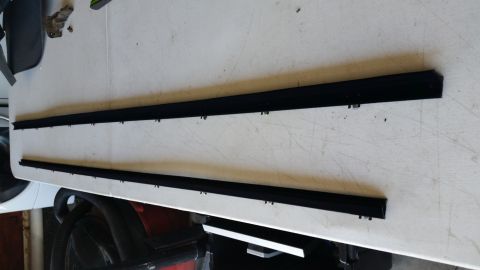 1992 Ford Bronco - Two black trim and weatherstripping pieces are shown, likely for a vehicle's rear glass installation.