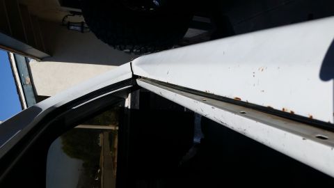 1992 Ford Bronco - Rust is visible on the door frame of this white vehicle, near the weatherstripping.
