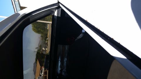 1992 Ford Bronco - The photo shows a close-up of a vehicle's door frame, focusing on the window seal and the interior panel.