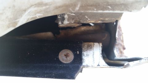 1992 Ford Bronco - Undercarriage detail showing a screw and trim piece, likely from a truck or truck.