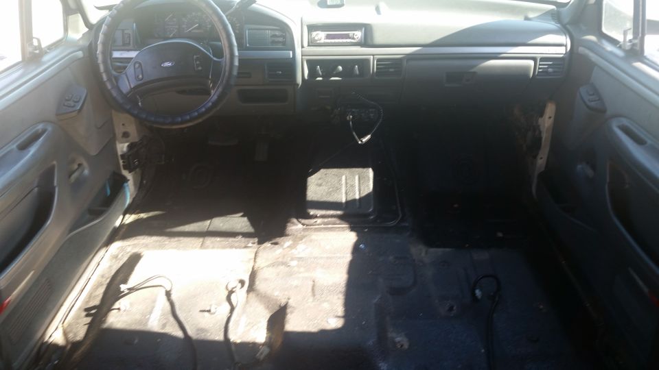1992 Ford Bronco interior, showing dashboard, steering wheel, and empty floor