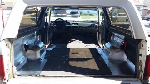 1992 Ford Bronco - Interior view of a 1992 Ford Bronco, showing removed seats and insulation.