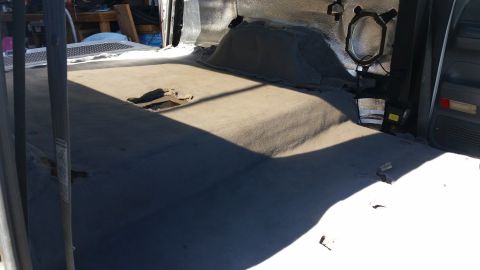 1992 Ford Bronco - The interior of this vehicle shows significant wear and tear on the carpet, with exposed sections of the floor visible.