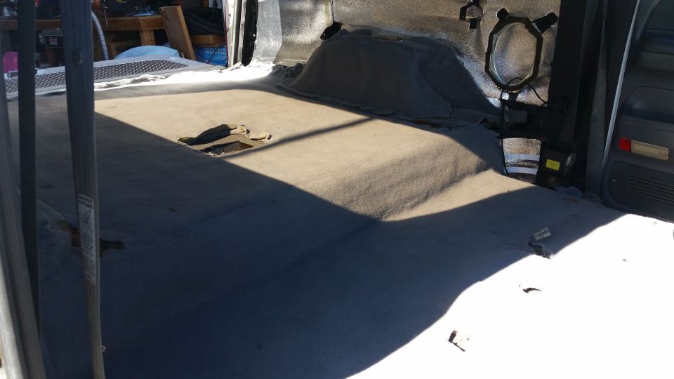 Interior of vehicle with torn carpet and exposed floor