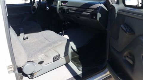 1992 Ford Bronco - The interior of a truck is shown, the driver's seat and dashboard area.
