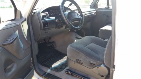 1992 Ford Bronco - The interior of a 1992 Ford Bronco is visible, gray seats and a dashboard.