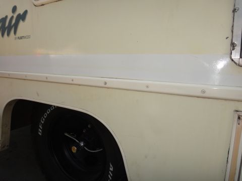 1995 Chevrolet P30 1 Ton - Step Van - Side view of a Fleetwood motorhome, showing the body panel and a tire.