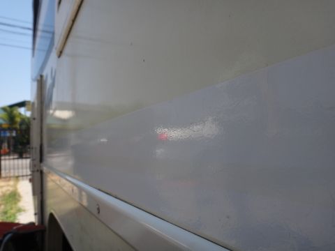 1995 Chevrolet P30 1 Ton - Step Van - Close-up of the side panel of a step van, showing a horizontal stripe detail.